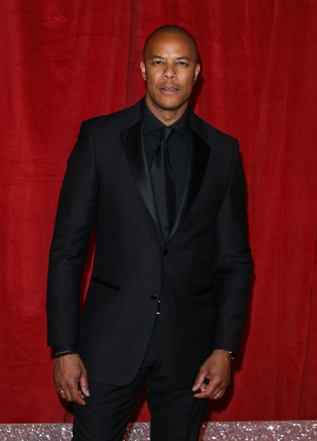 Michael Wildman smoulders in the red carpet at the British Soap Awards in a black suit