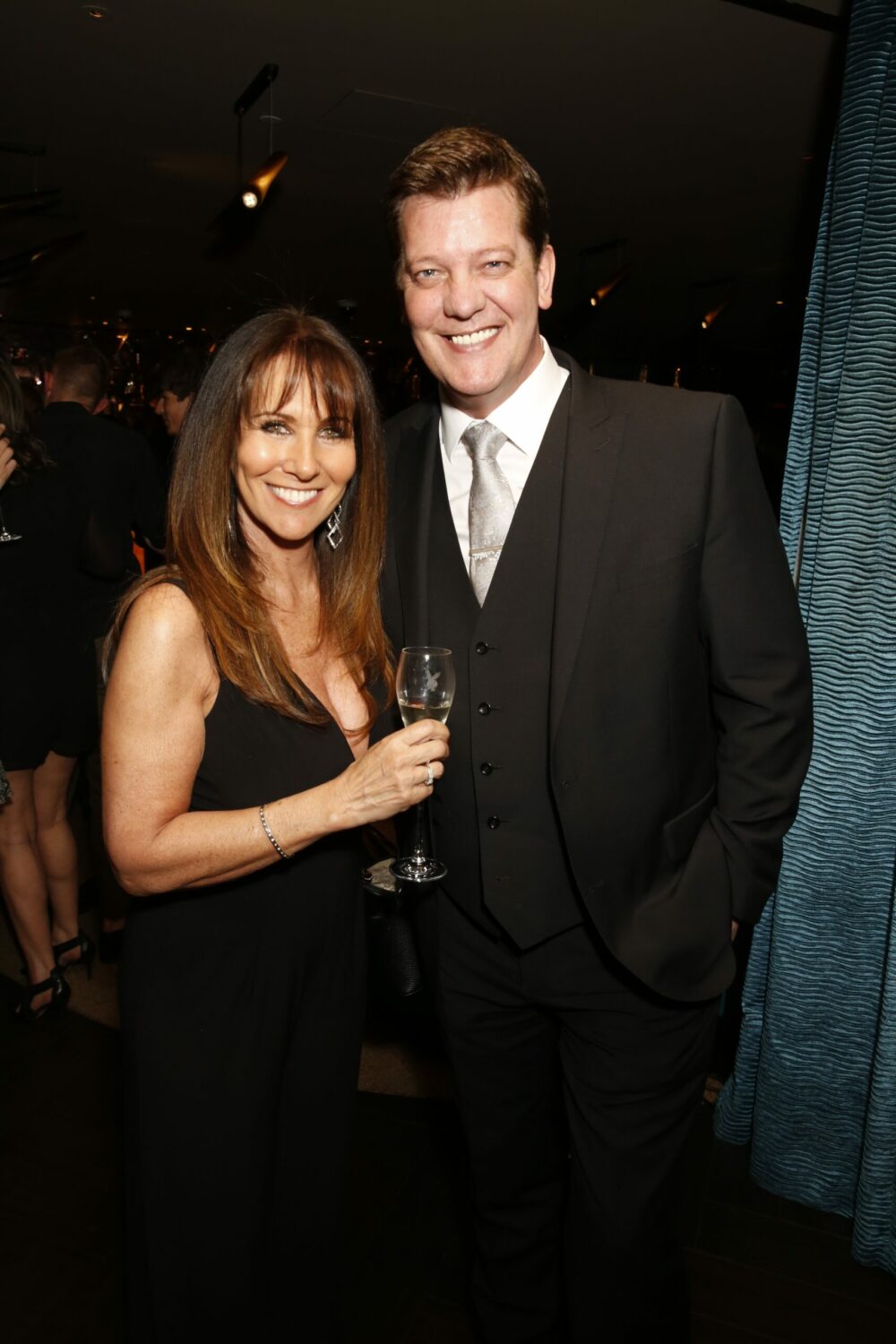 Linda Lusardi and husband Sam Kane smile as they pose with champagne