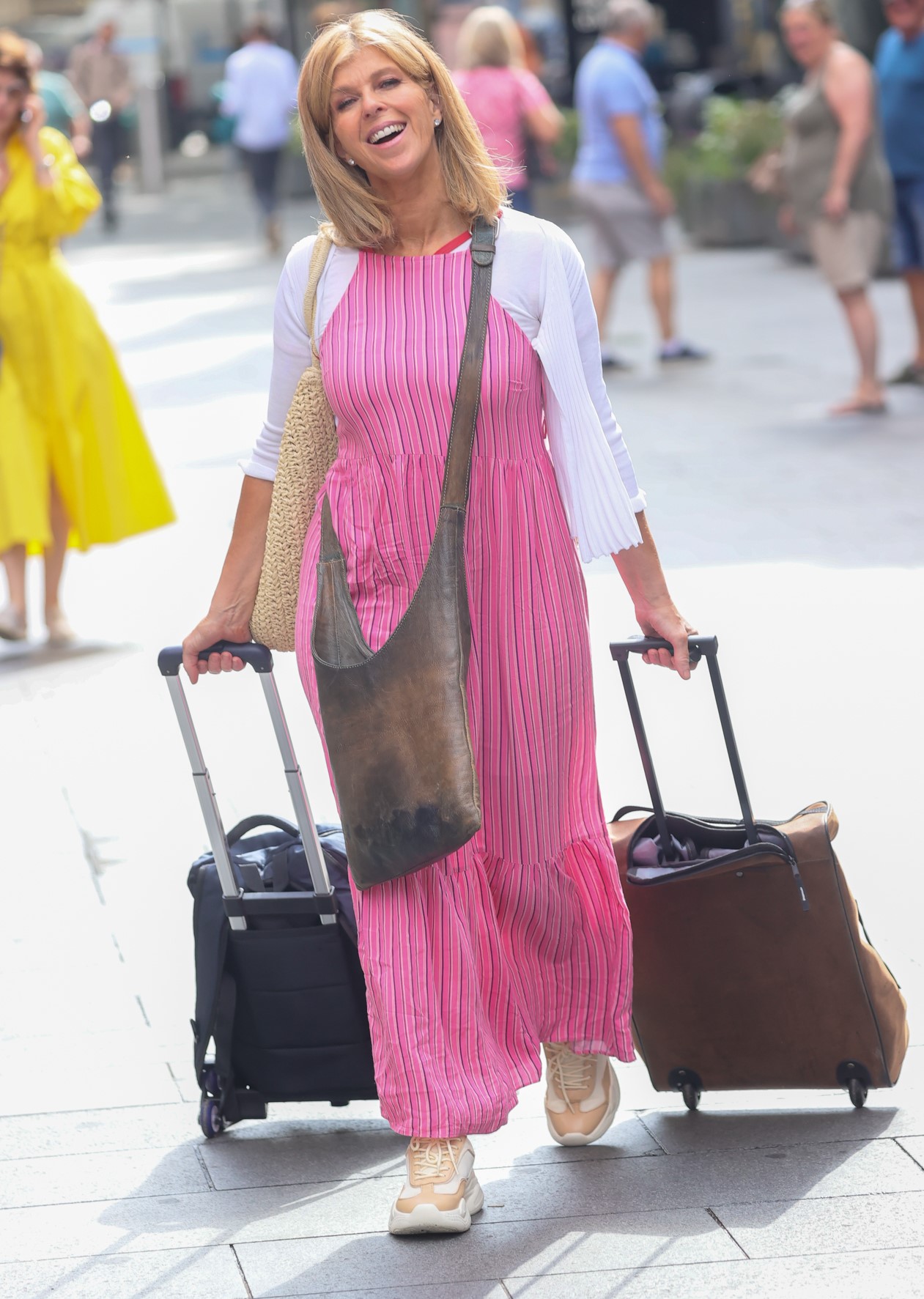 Kate Garraway pulls two suitcases in pink outfit