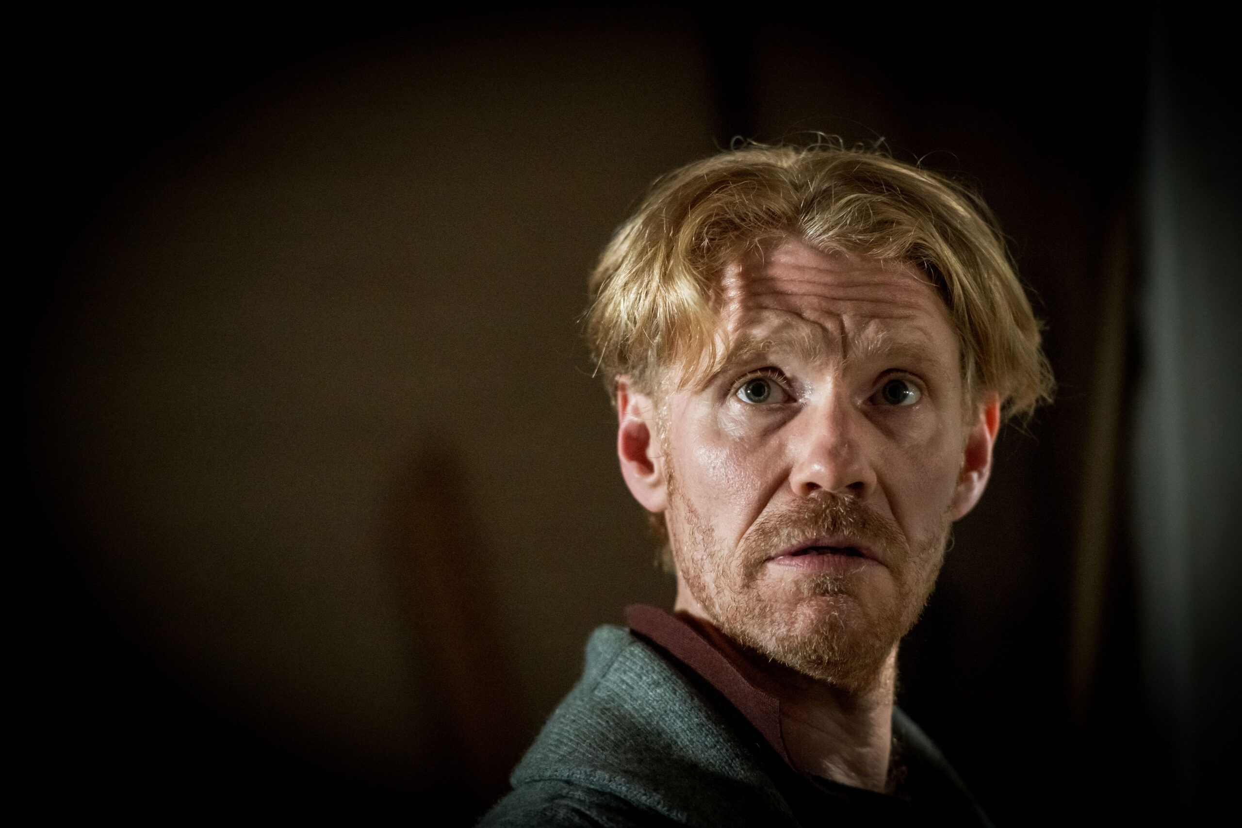 MICHAEL SCHAEFFER as Weird Snr, he looks into the camera, looking stressed and dishellved