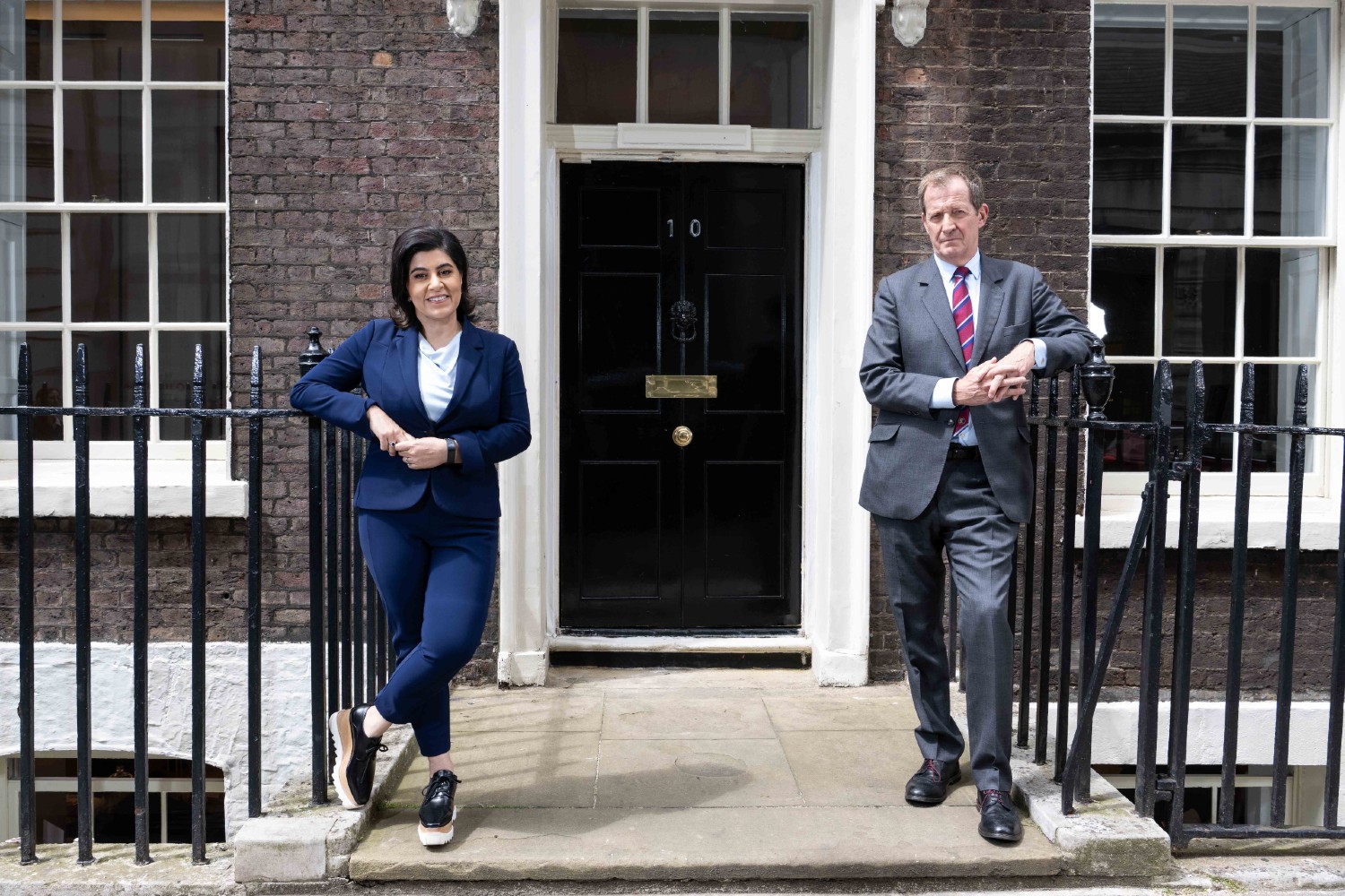 Alastair Campbell and Sayeeda Warsi standing outside 10 Downing Street