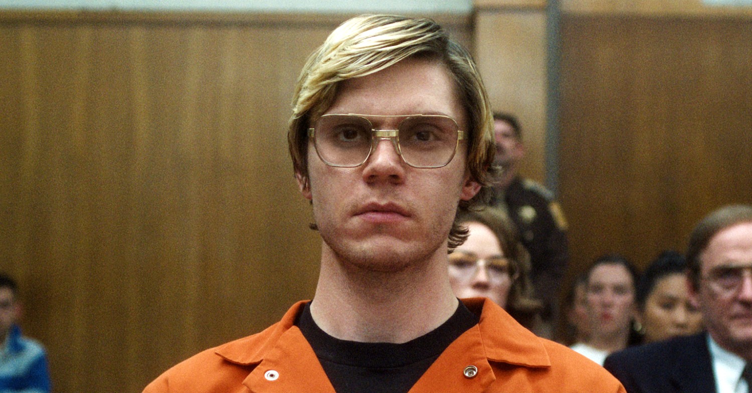 Evan Peters wearing glasses and an orange jumpsuit in Monster: The Jeffrey Dahmer Story