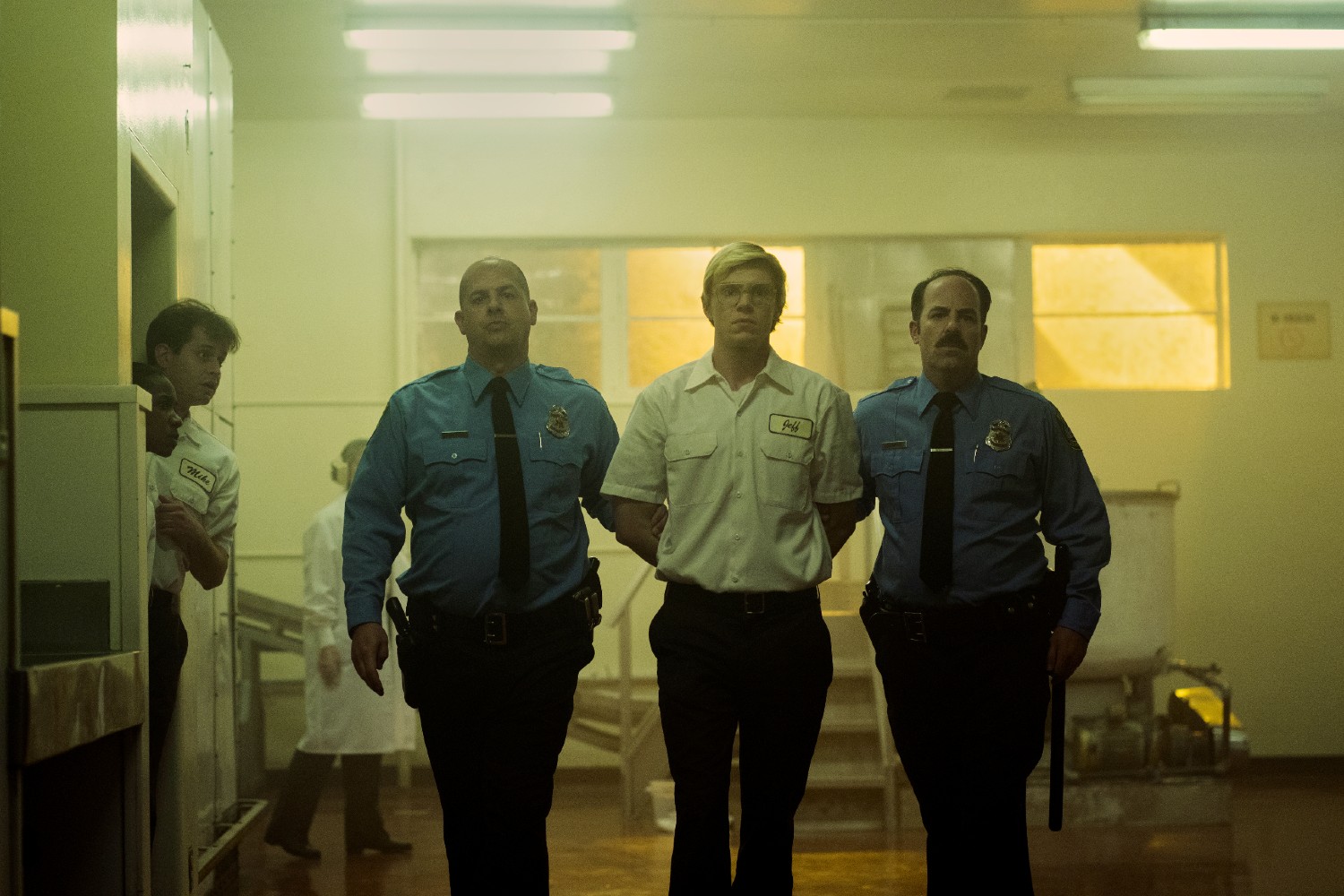 Evan Peters under arrest in the Netflix series Monster: The Jeffery Dahmer Story