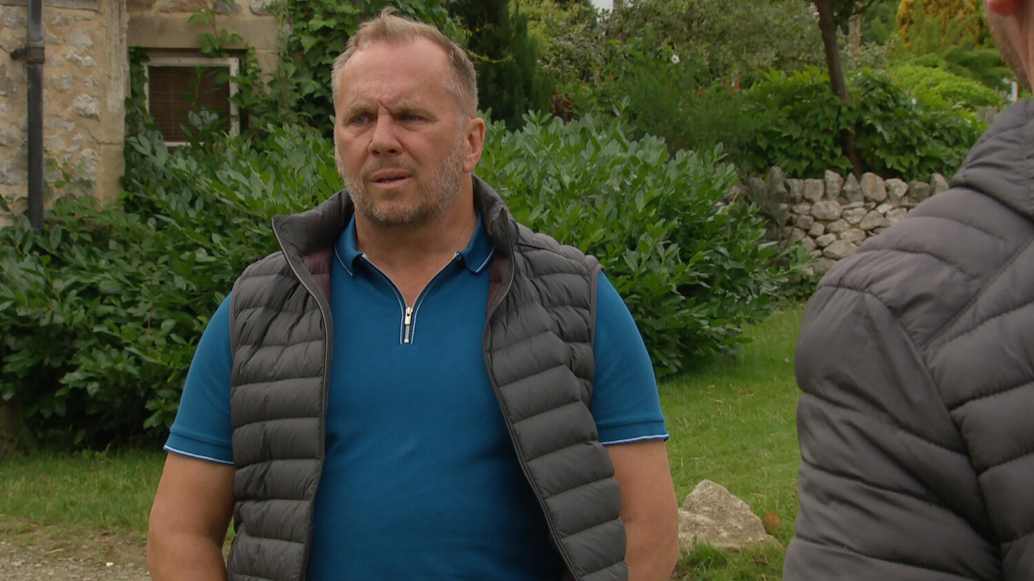 Will standing outside looking torn in Emmerdale