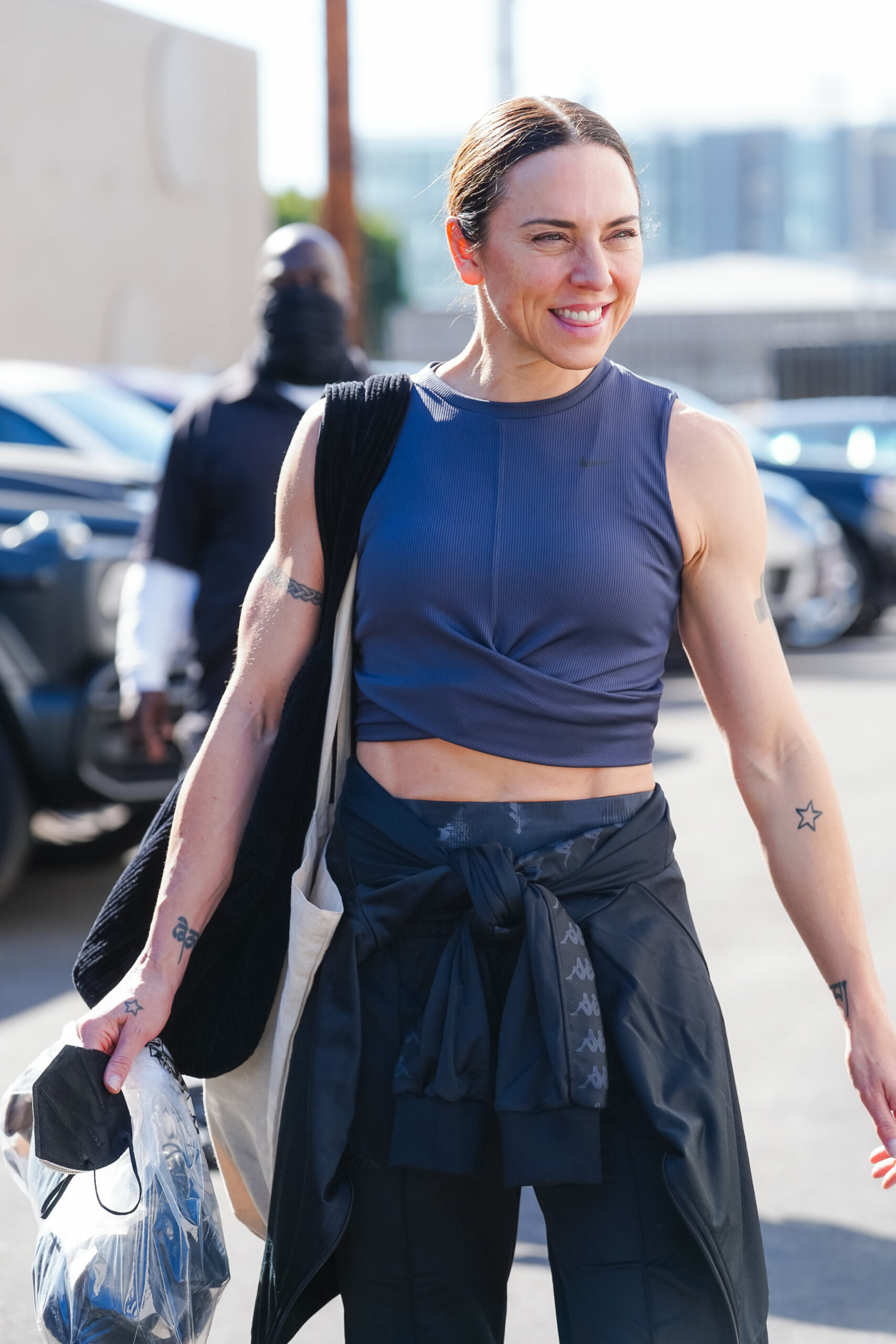 Mel C (or Sporty Spice) wearing sporty clothes and smiling. 