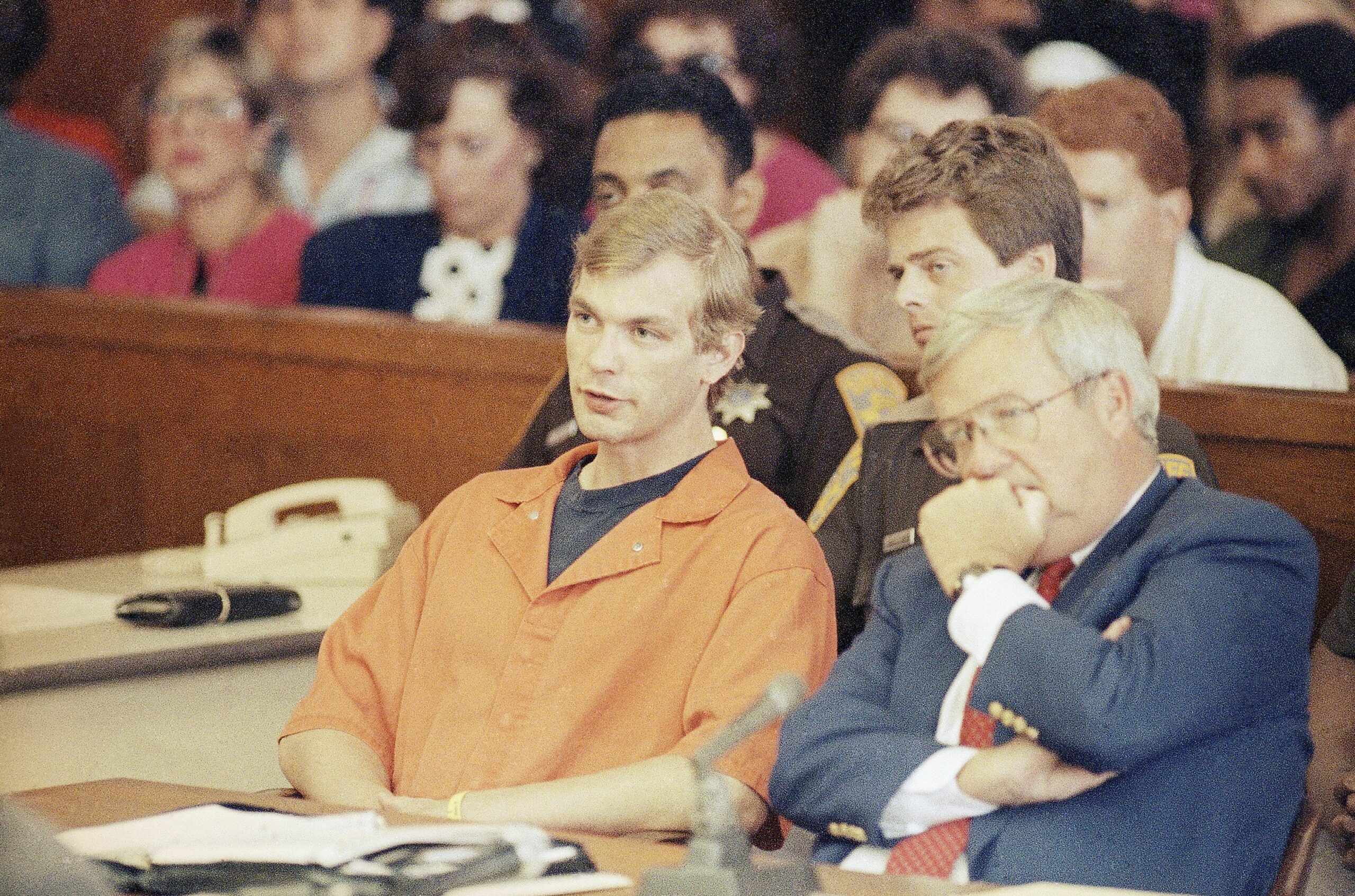 Jeffrey Dahmer in orange prison overalls attends court