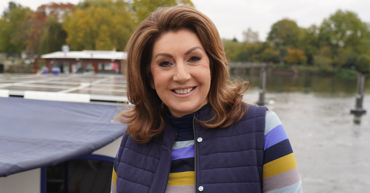 Jane McDonald smiling on a boat