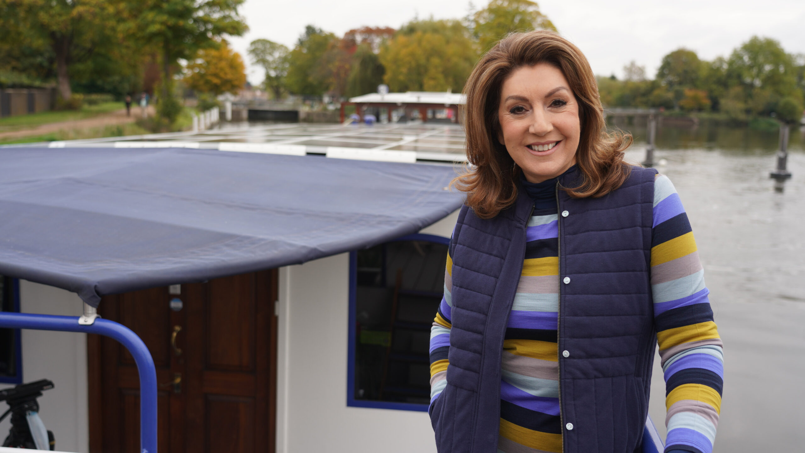 Jane McDonald smiling on a boat
