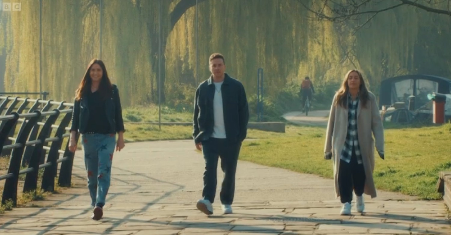 Lisa Snowdon, Danny Jones, and Mel Blatt walking through a park on celebrity Masterchef 2022 