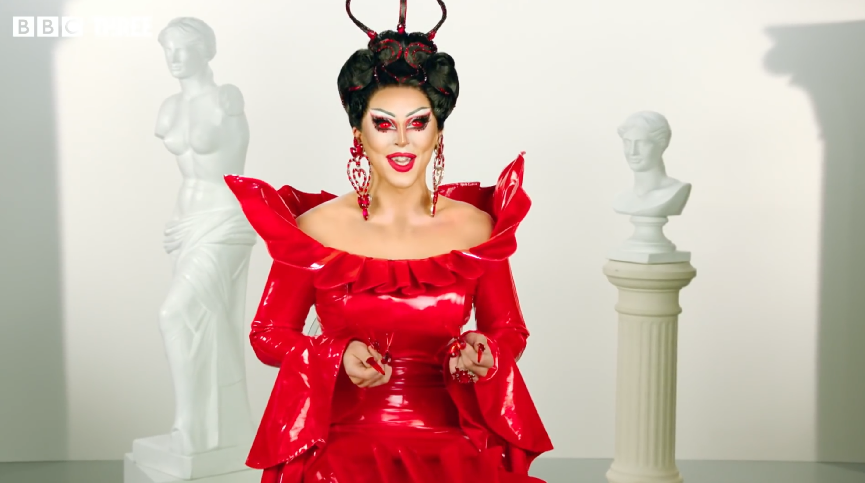 RuPaul's Drag Race Cherry Valentine in a red costume