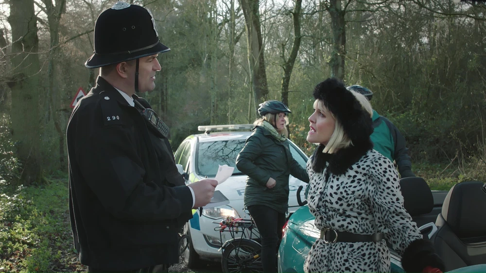 Marc Bannerman as Gary Beech in Agatha Raisin, he argues with Agatha next to a police car in a forest
