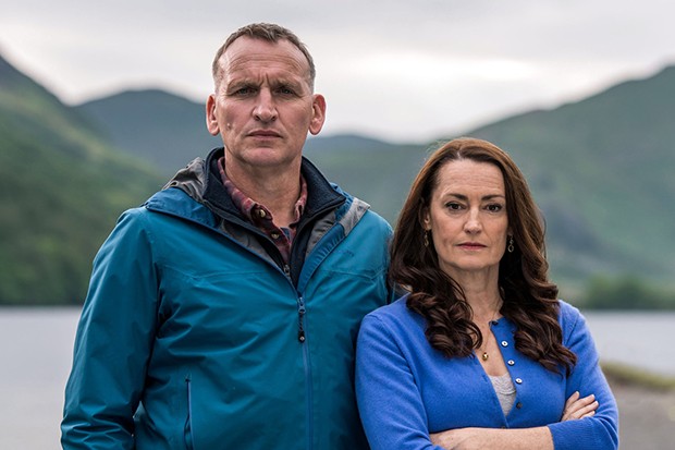 Christopher Eccleston as Maurice (left) and Pooky Quisnel as Louise (right) in The A Word, they are outside as they stand together with small smiles