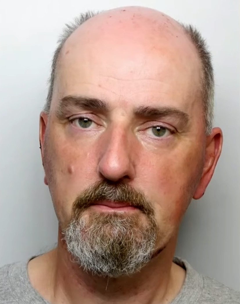 Thomas Mair's mug shot, he wears a grey shirt and has a small frown