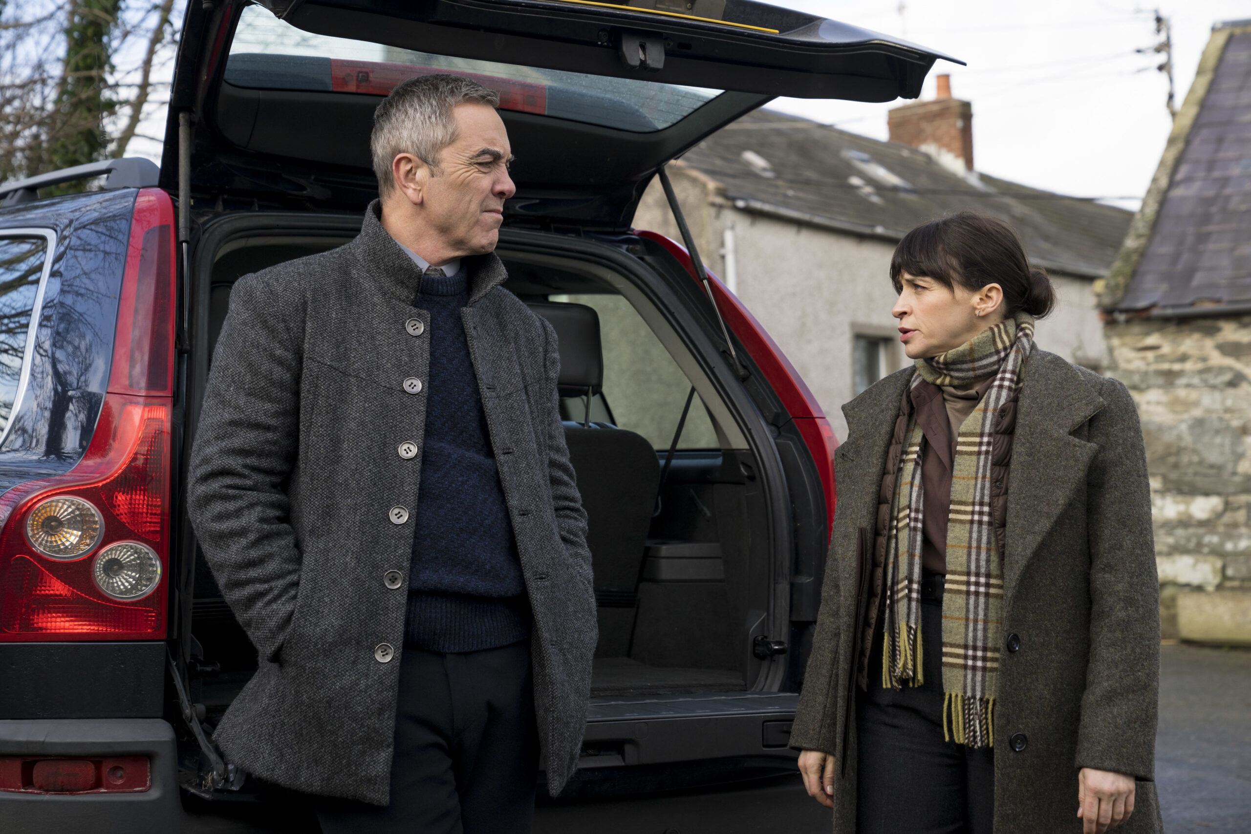 Bloodlands episode 3 Tom Brannick (JAMES NESBITT), Niamh McGovern (CHARLENE McKENNA) they stand in front of a car, looking at each other with intense expressions