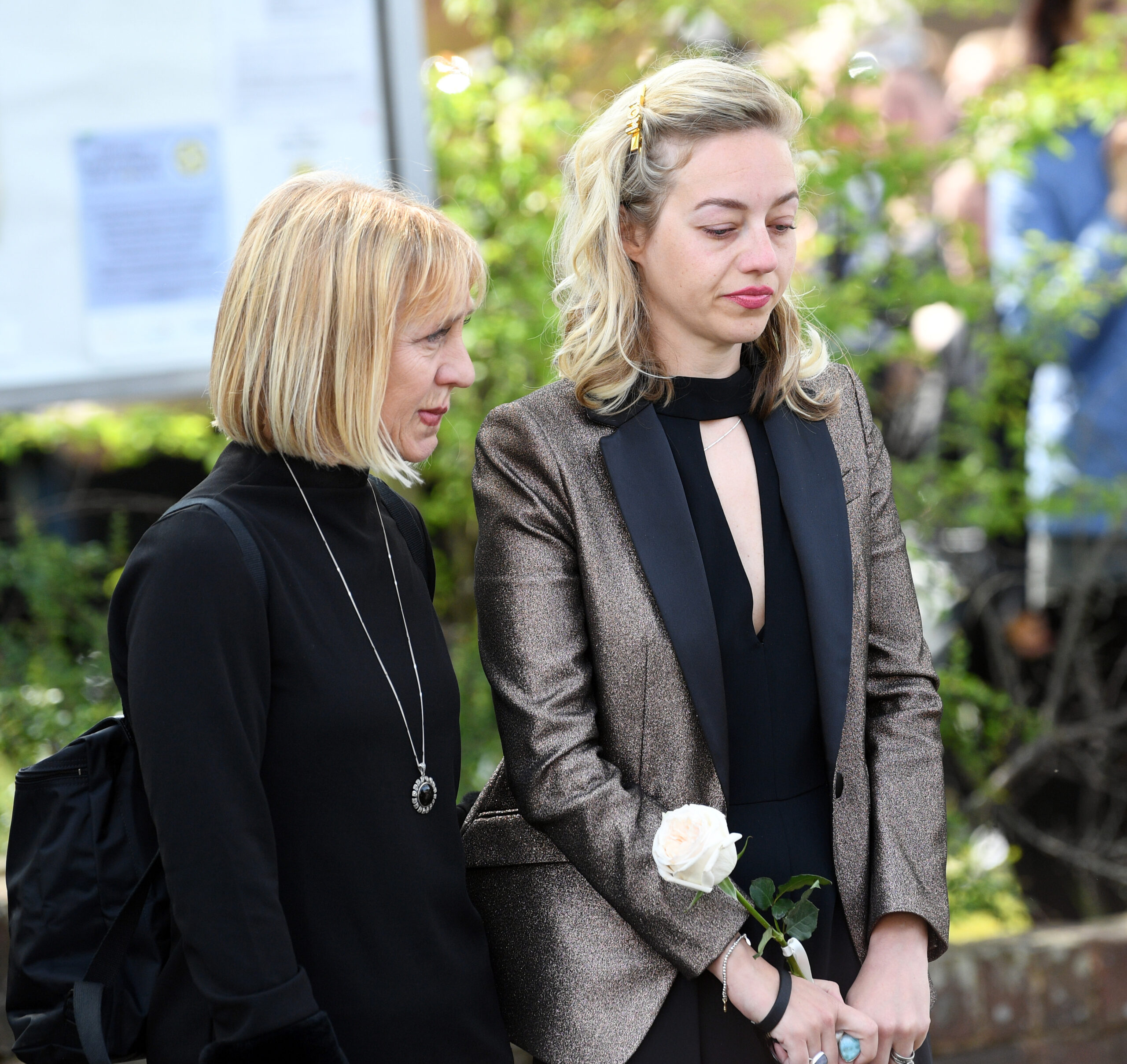 Kelsey Parker holding a rose in a black dress