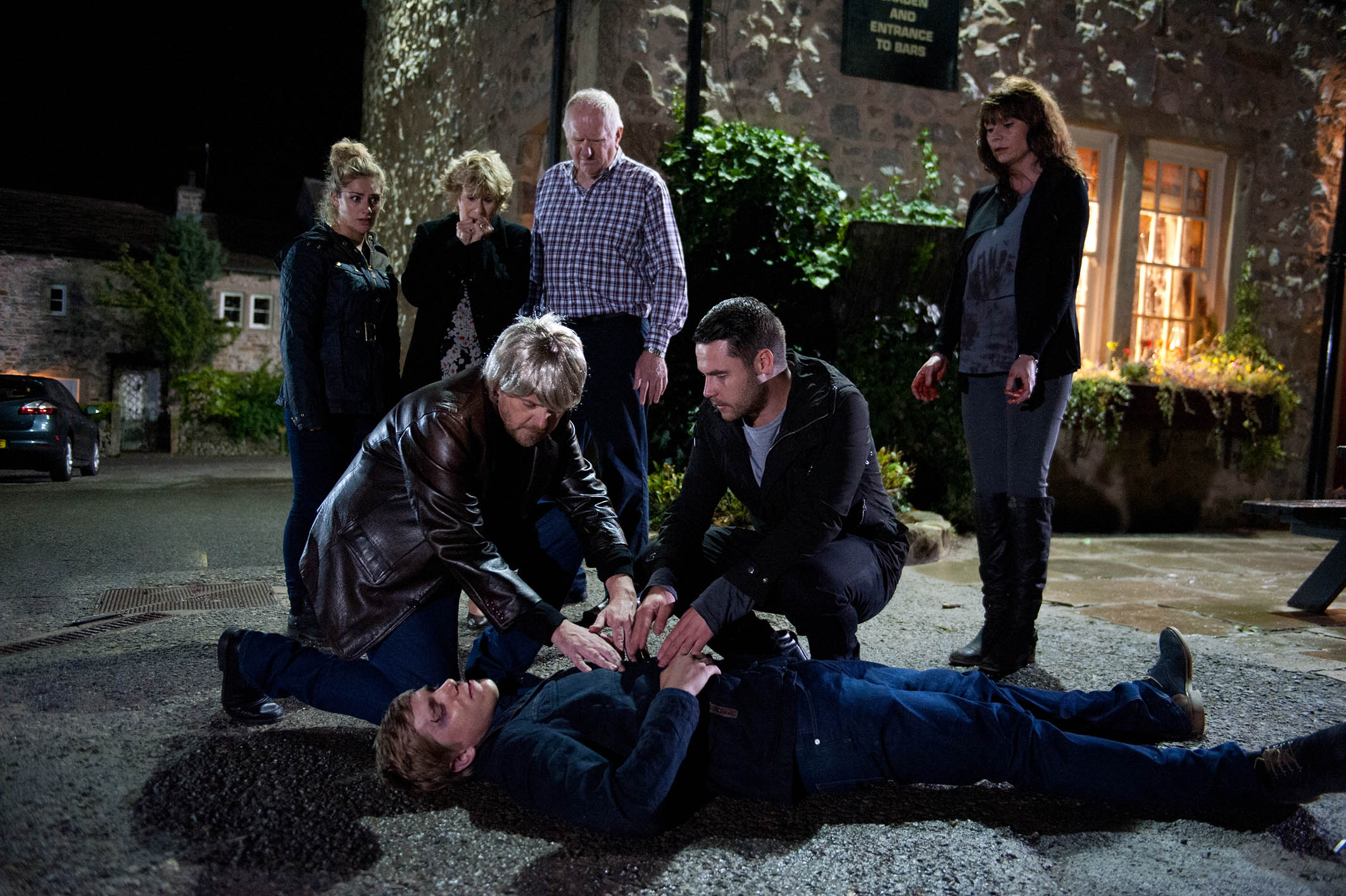 Robert lies on the ground after being shot