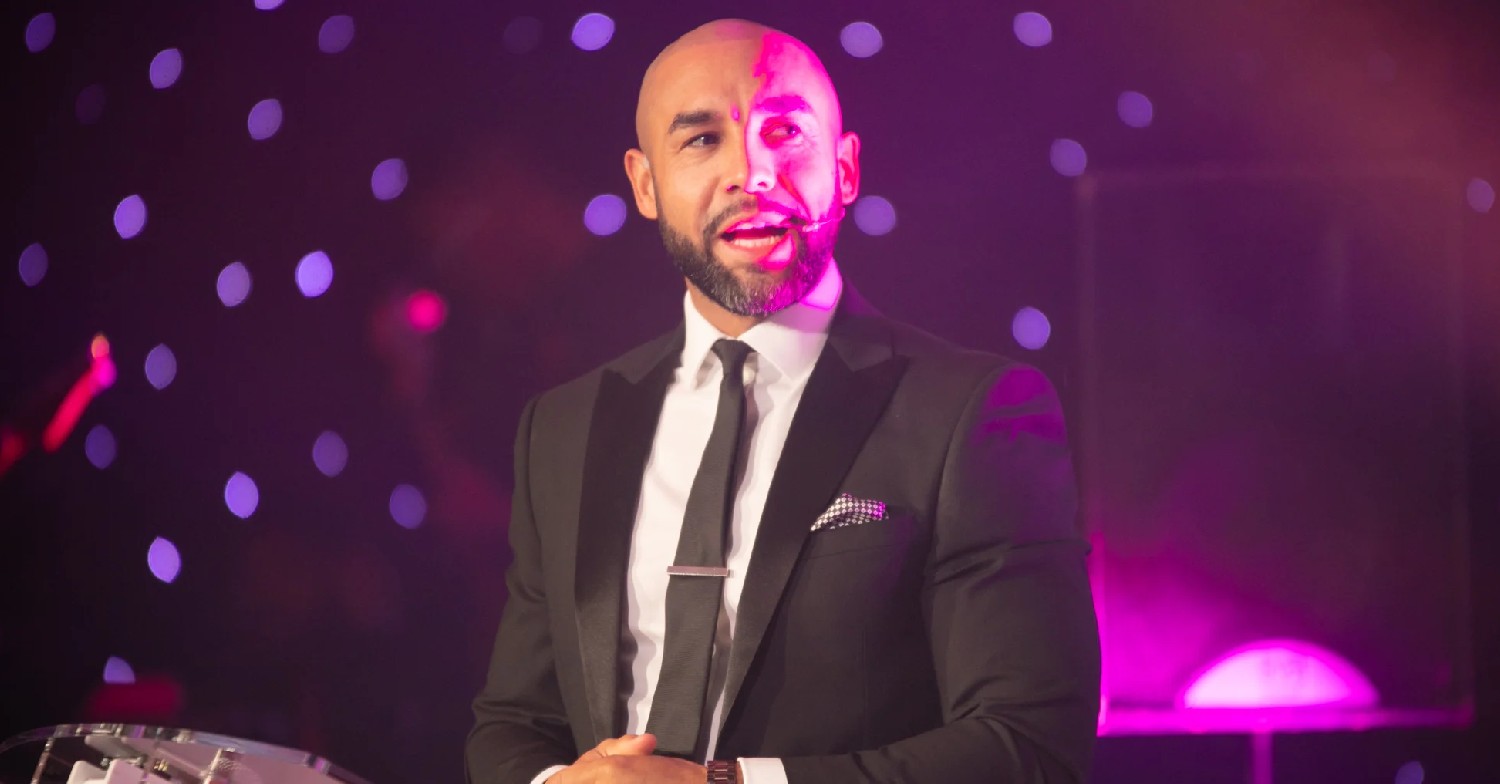 Alex Beresford speaking into a microphone