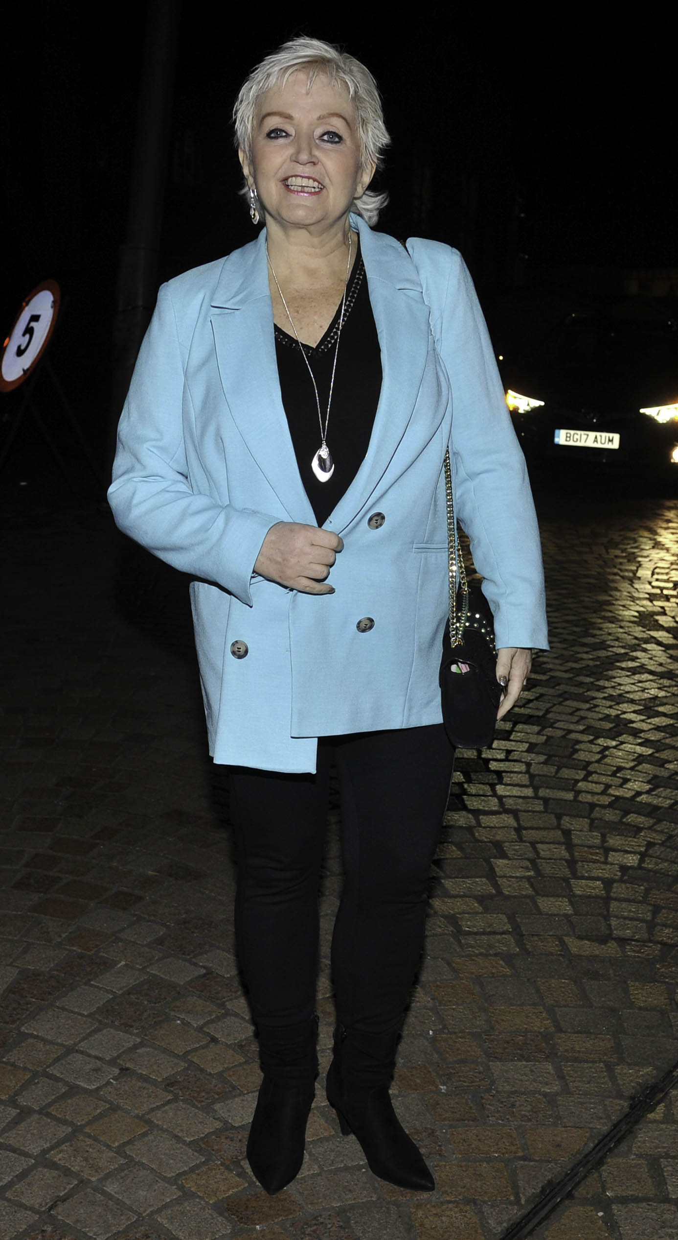 Linda Colan smiling wearing a blue jacket