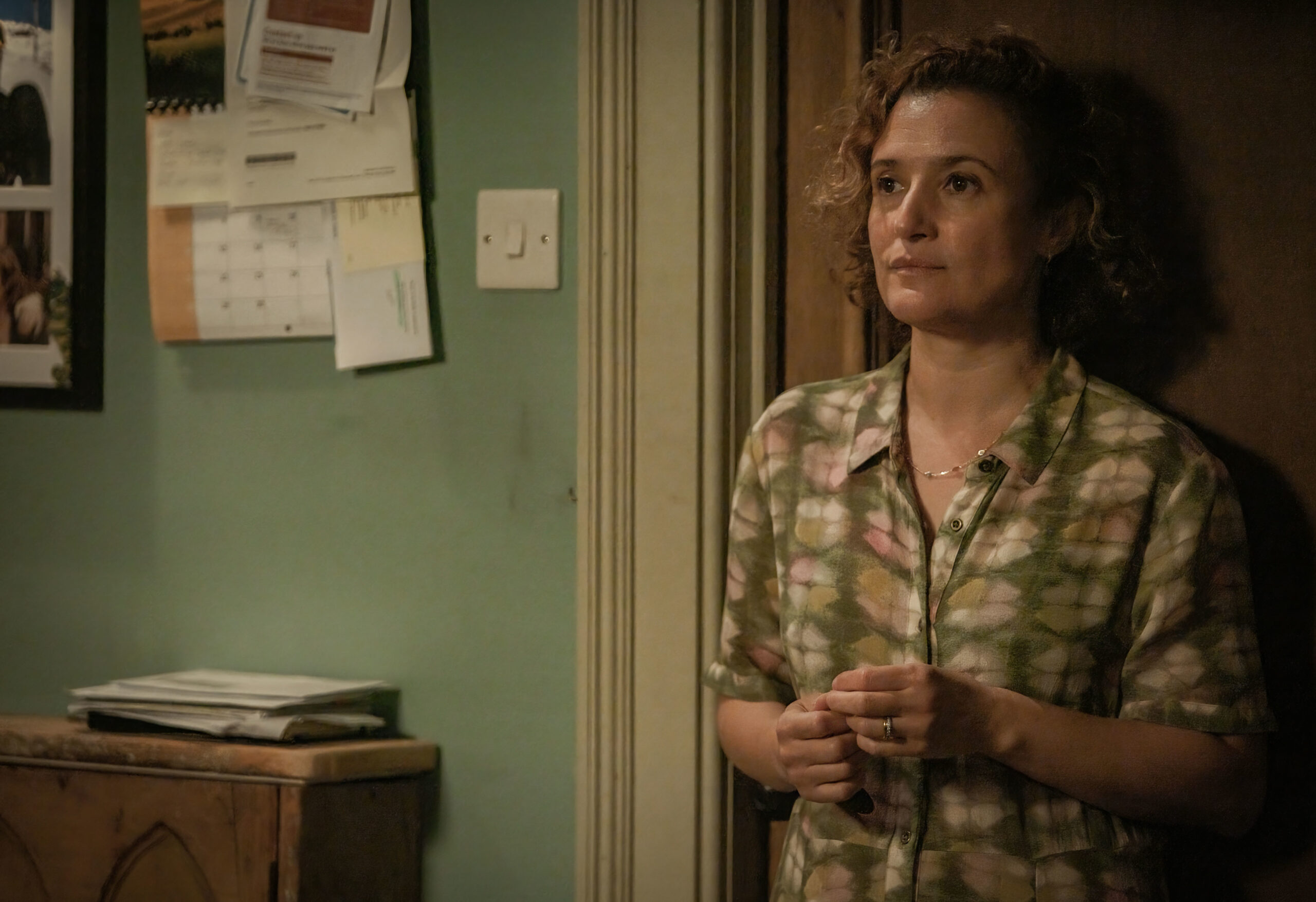 Lyndsey Marshall as Mary Watling in Inside Man, she stands in the watling home with a worried expression 