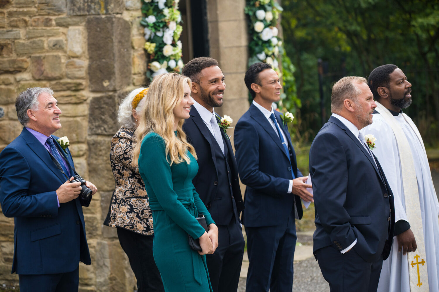 Emmerdale wedding guests standing outside of the Church