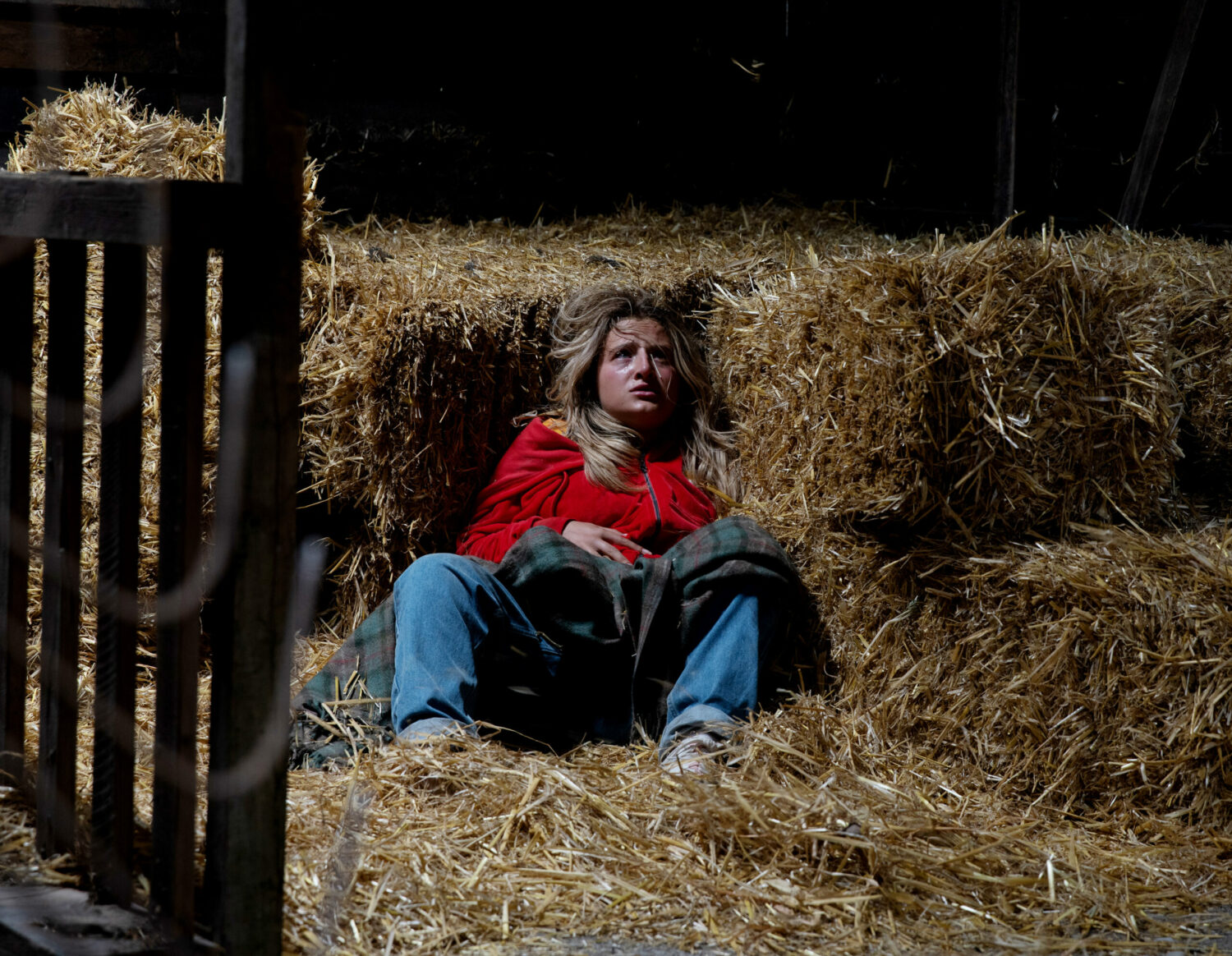 Emmerdale's Amelia lies in a barn surrounded by hay looking in pain