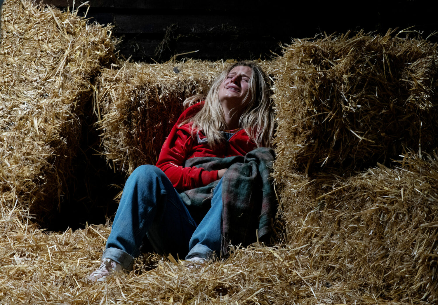 Amelia in pain crying in the hay Coronation Street