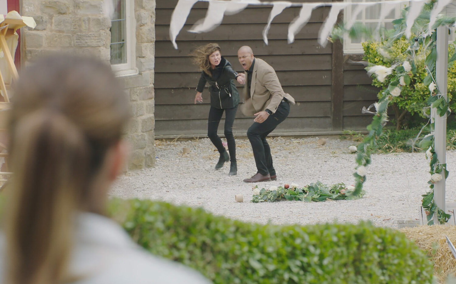 Emmerdale Chas and Al holding on to each other in the storm, with Kerry looking on