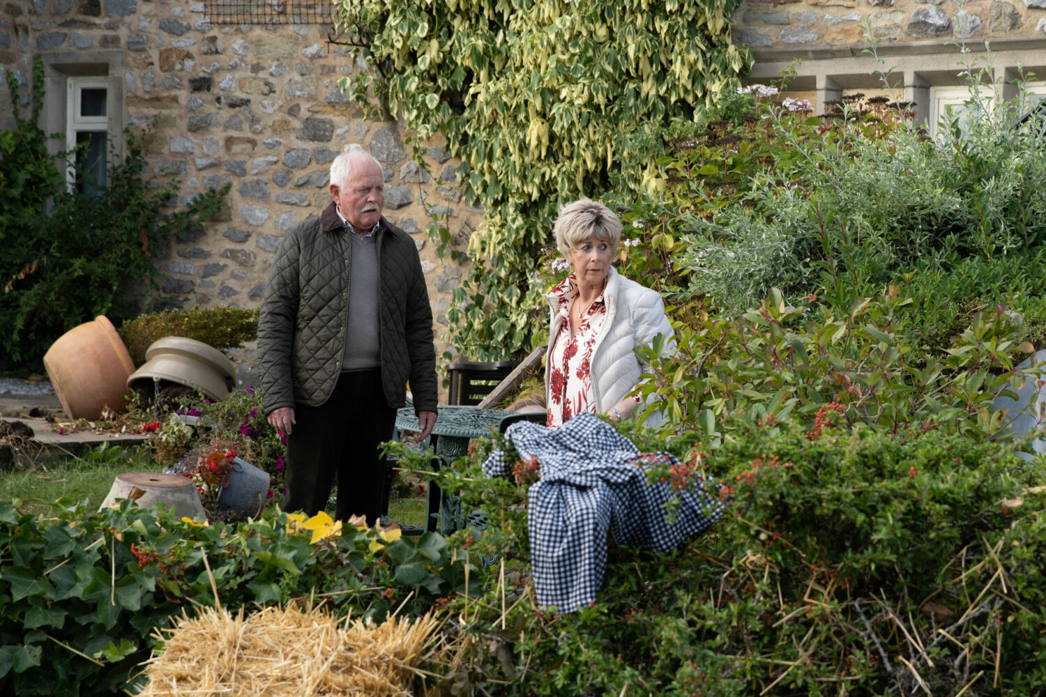 Diane and Eric looking sadly at all of the damage from the storm