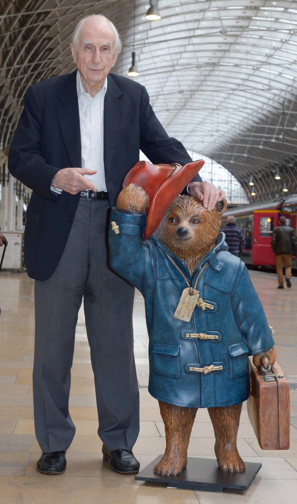 Michael Bond points at Paddington Bear