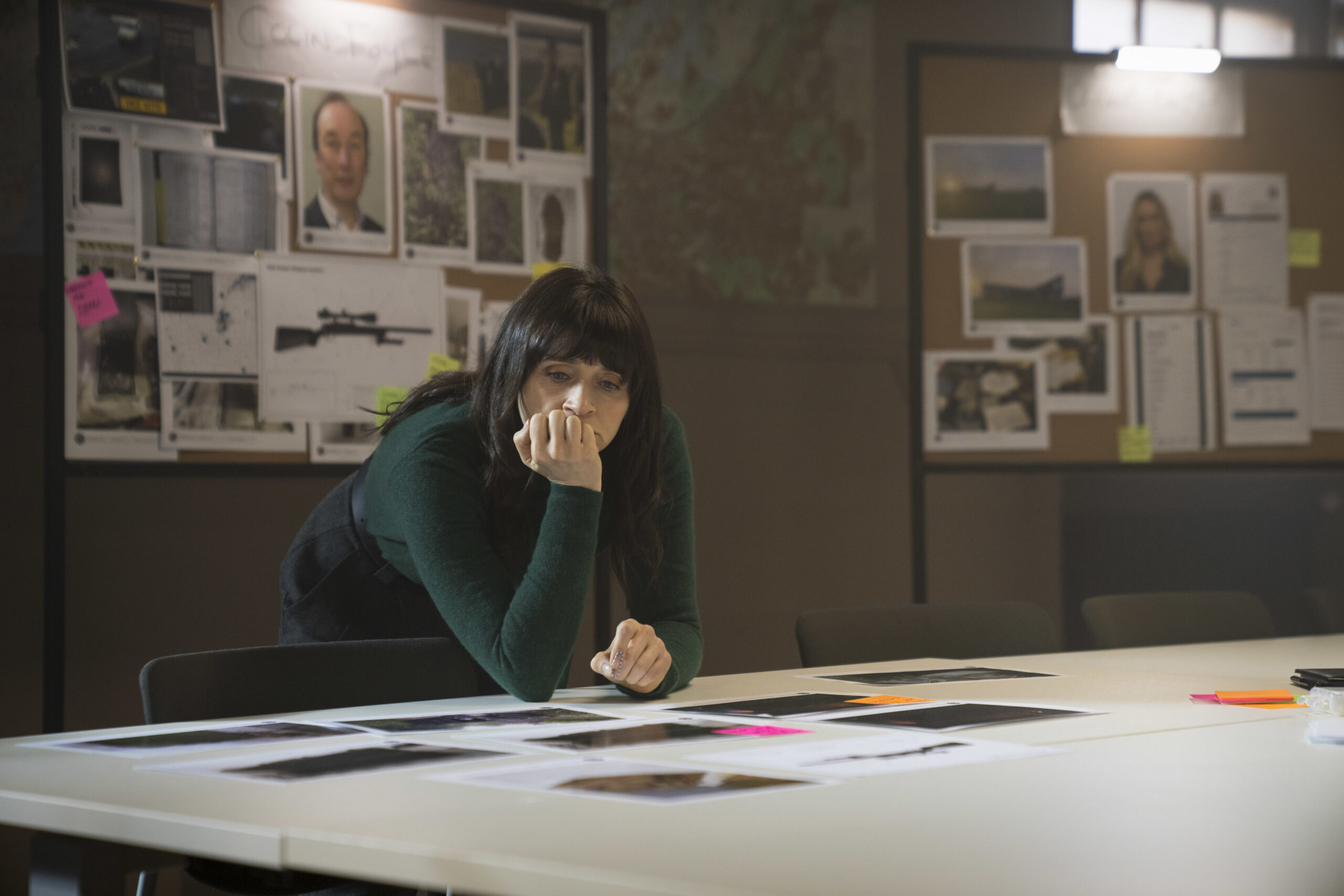 Charlene McKenna as Niamh McGovern in Bloodlands, she leans over a table with her hand on her face she frowns