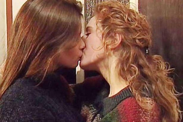 Anna Friel as Beth (left) and Nicola Stephenson as Margaret (right) in Brookside, the pair kiss next to a door