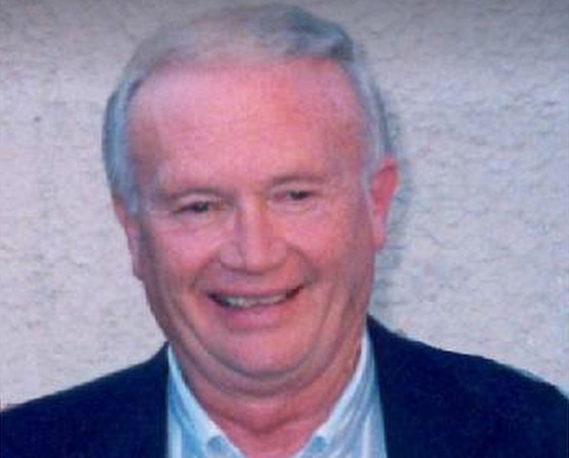 Image of Robert Berchtold in 2005, he smiles and sits in a suit