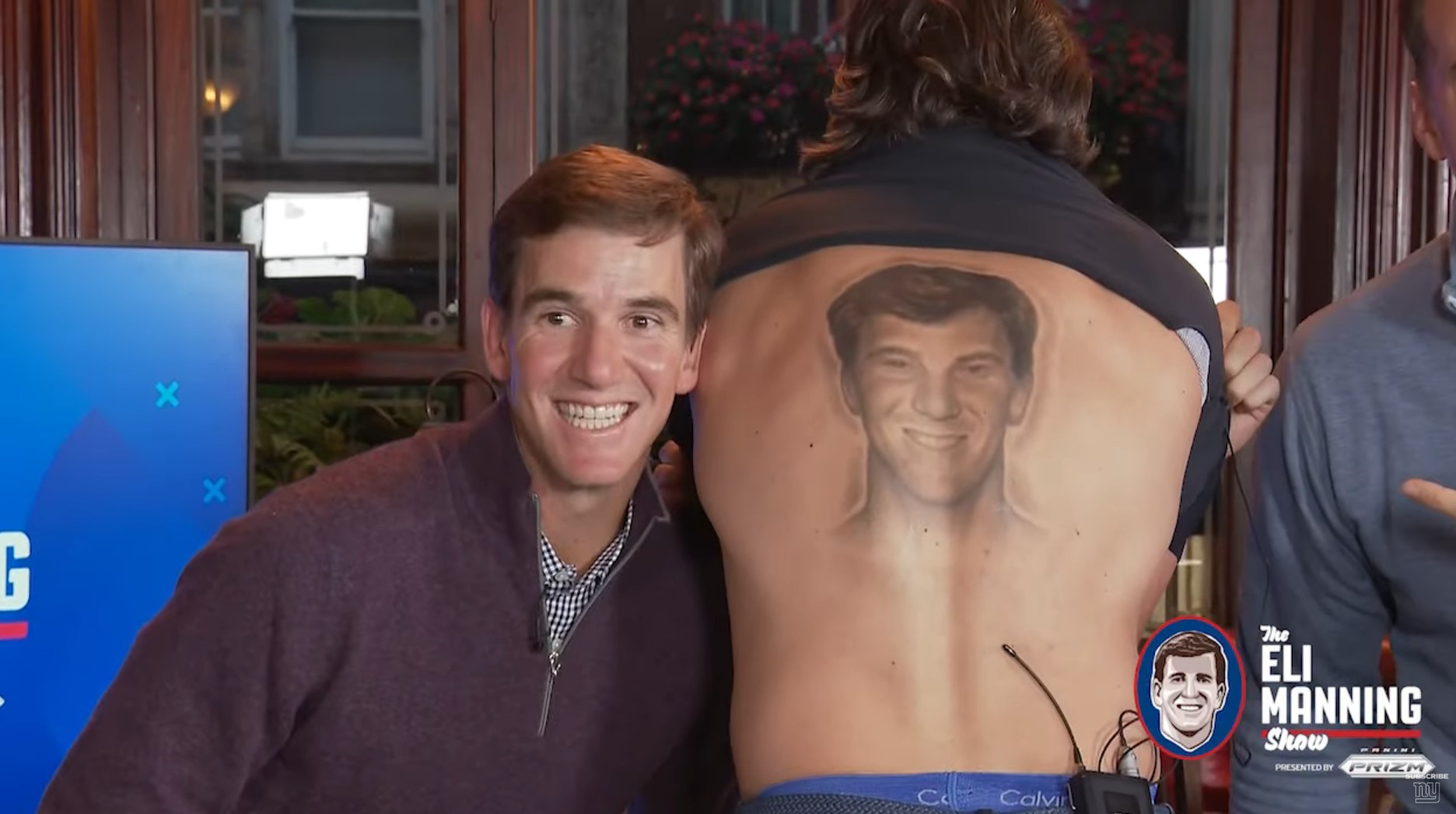 Eli Manning poses with Vernon Kay showing off his back tattoo