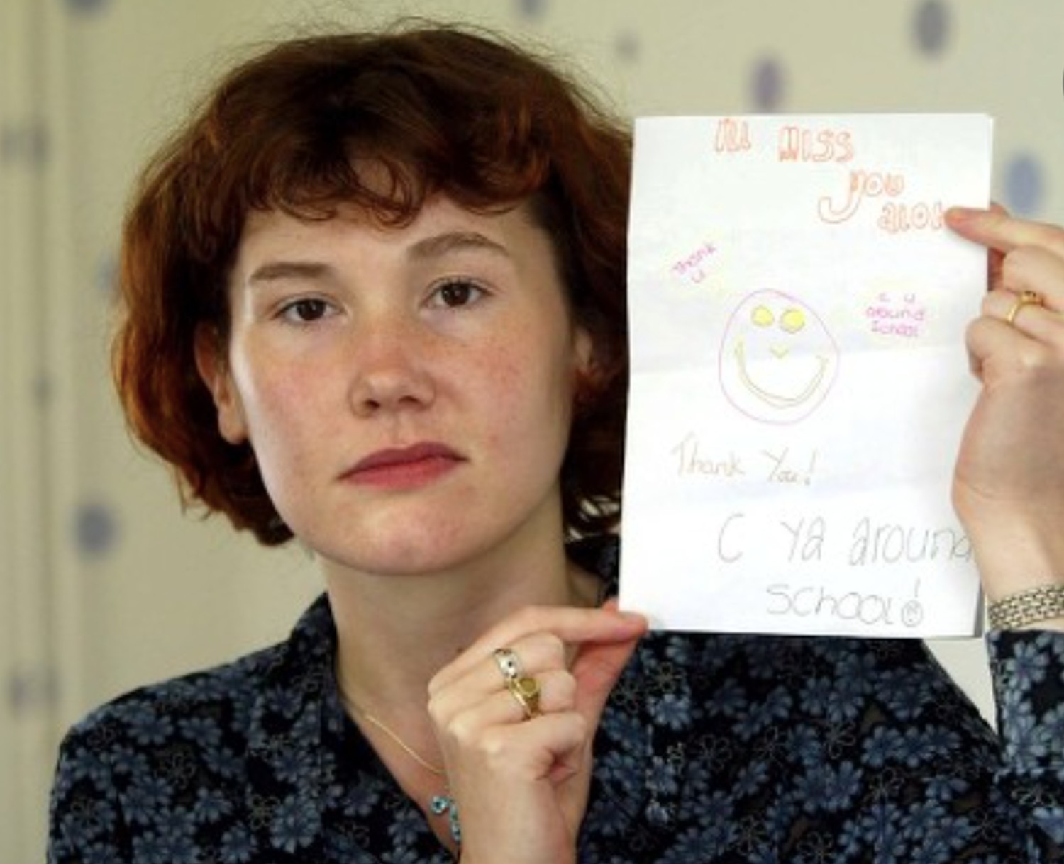 Maxine holding up a card Holly and Jessica made for her