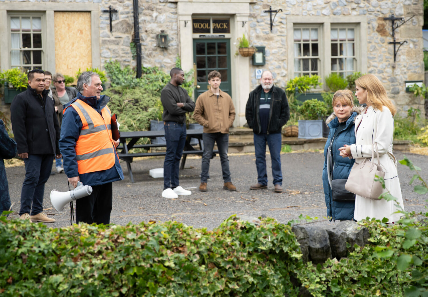 The villagers stand around surveying the damage