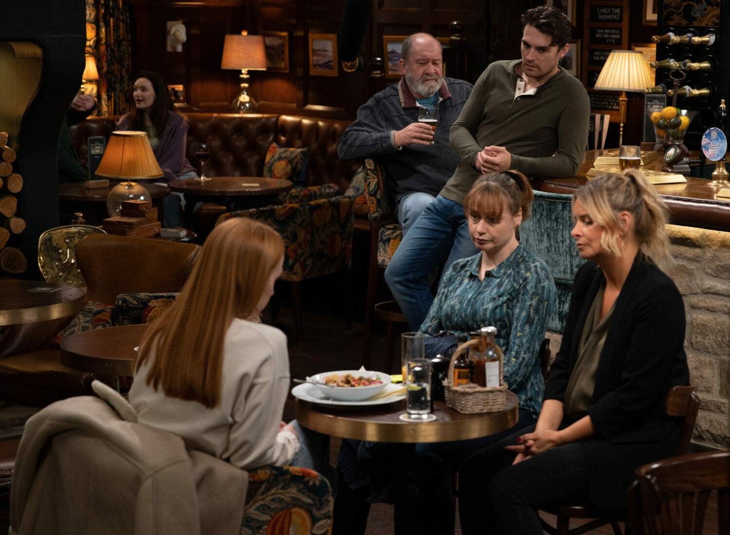 Mack watching Charity and Lydia chat to Chloe in Emmerdale 