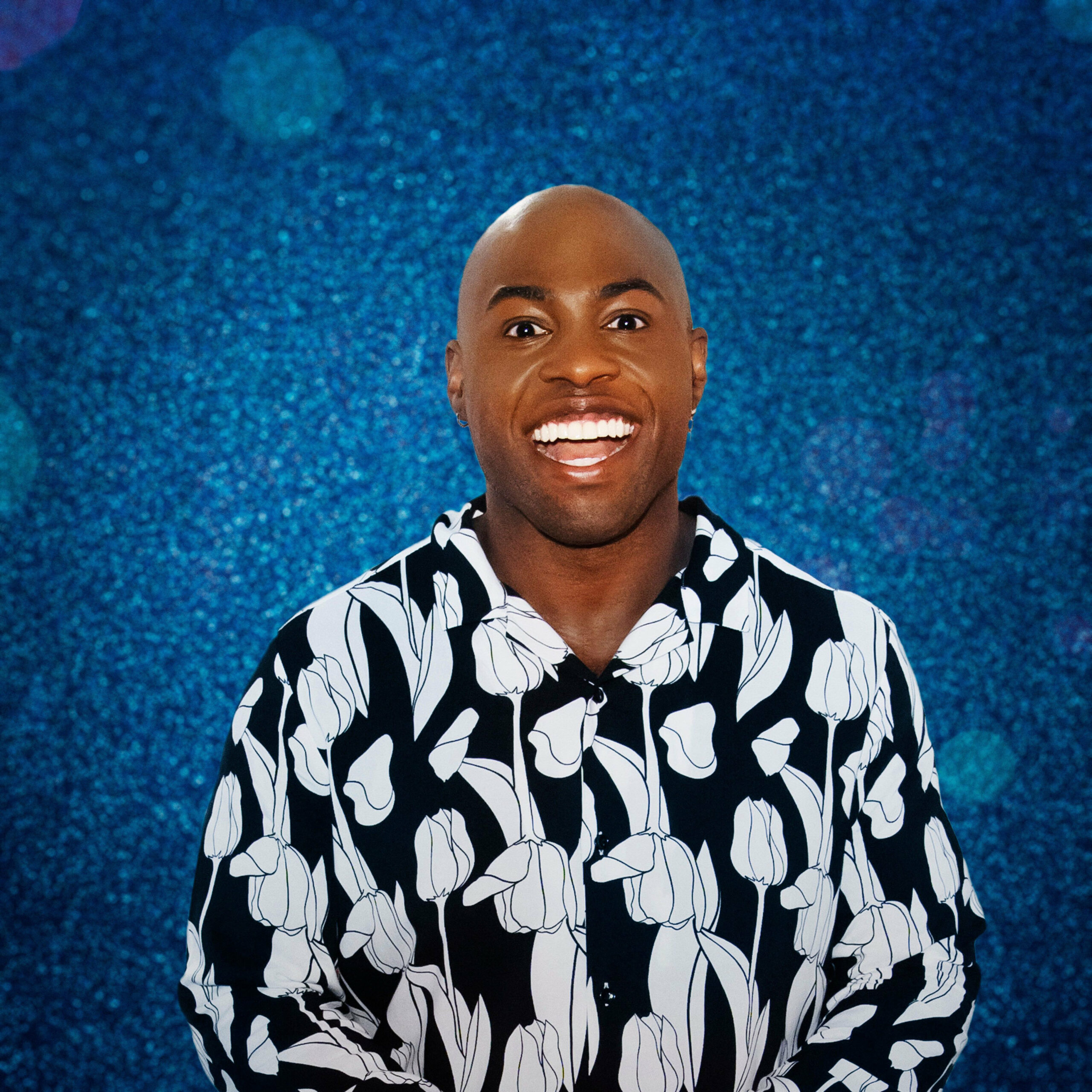 Darren Harriott standing in front of blue glitter boarding for Dancing On Ice