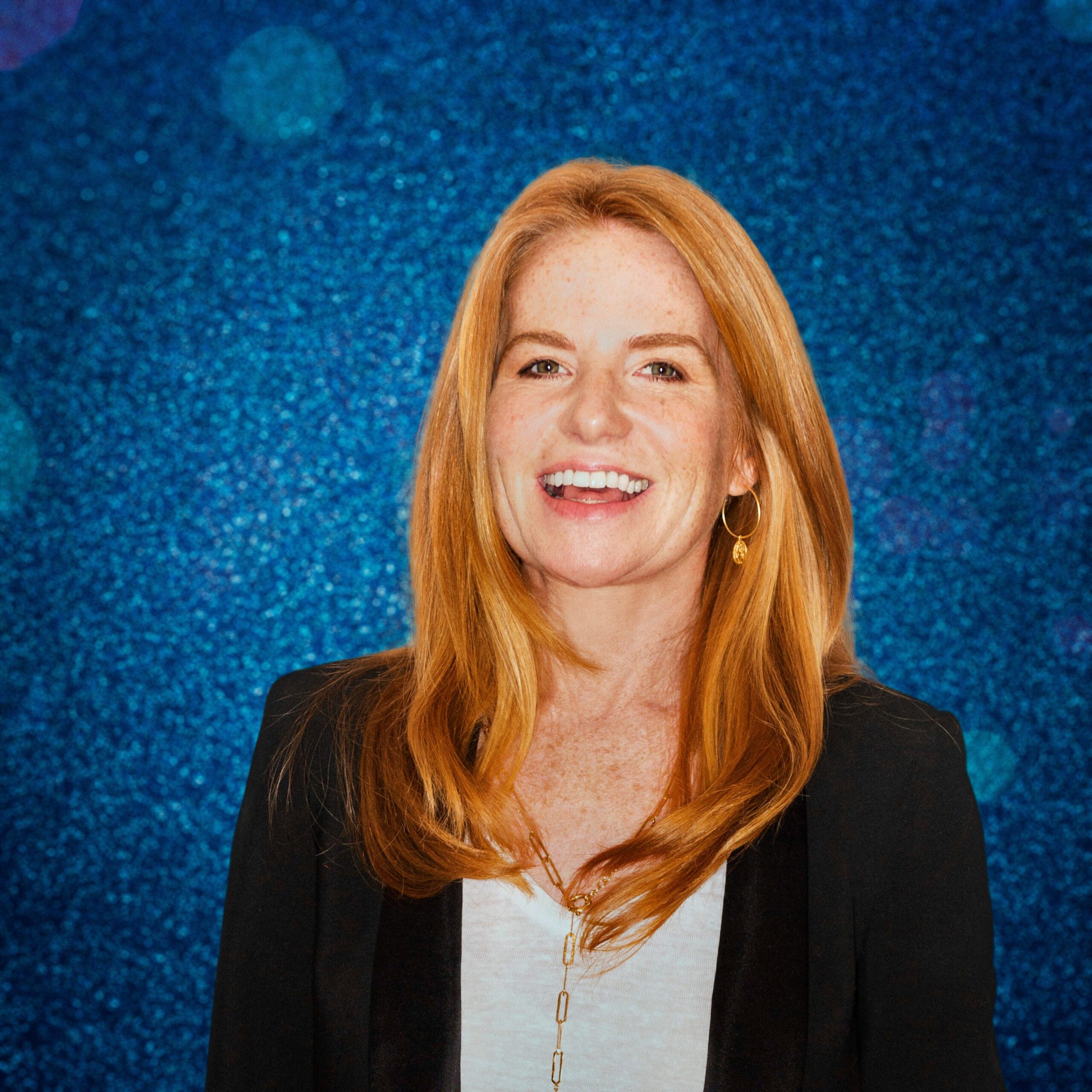 Patsy Palmer standing in front of blue glitter boarding for Dancing On Ice