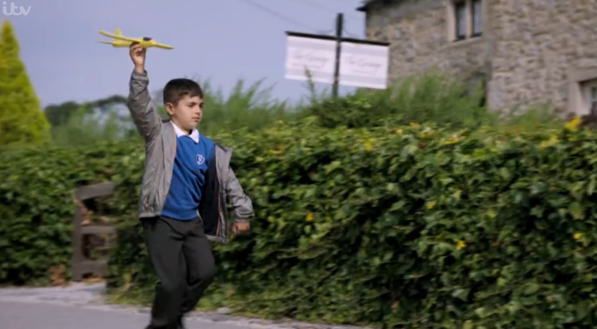 Emmerdale Johnny Woodfield flies a toy plane through the village