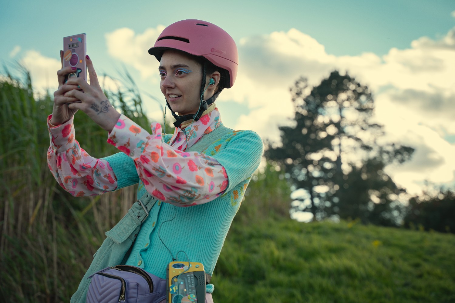 Tanya Reynolds taking a photo in Sex Education