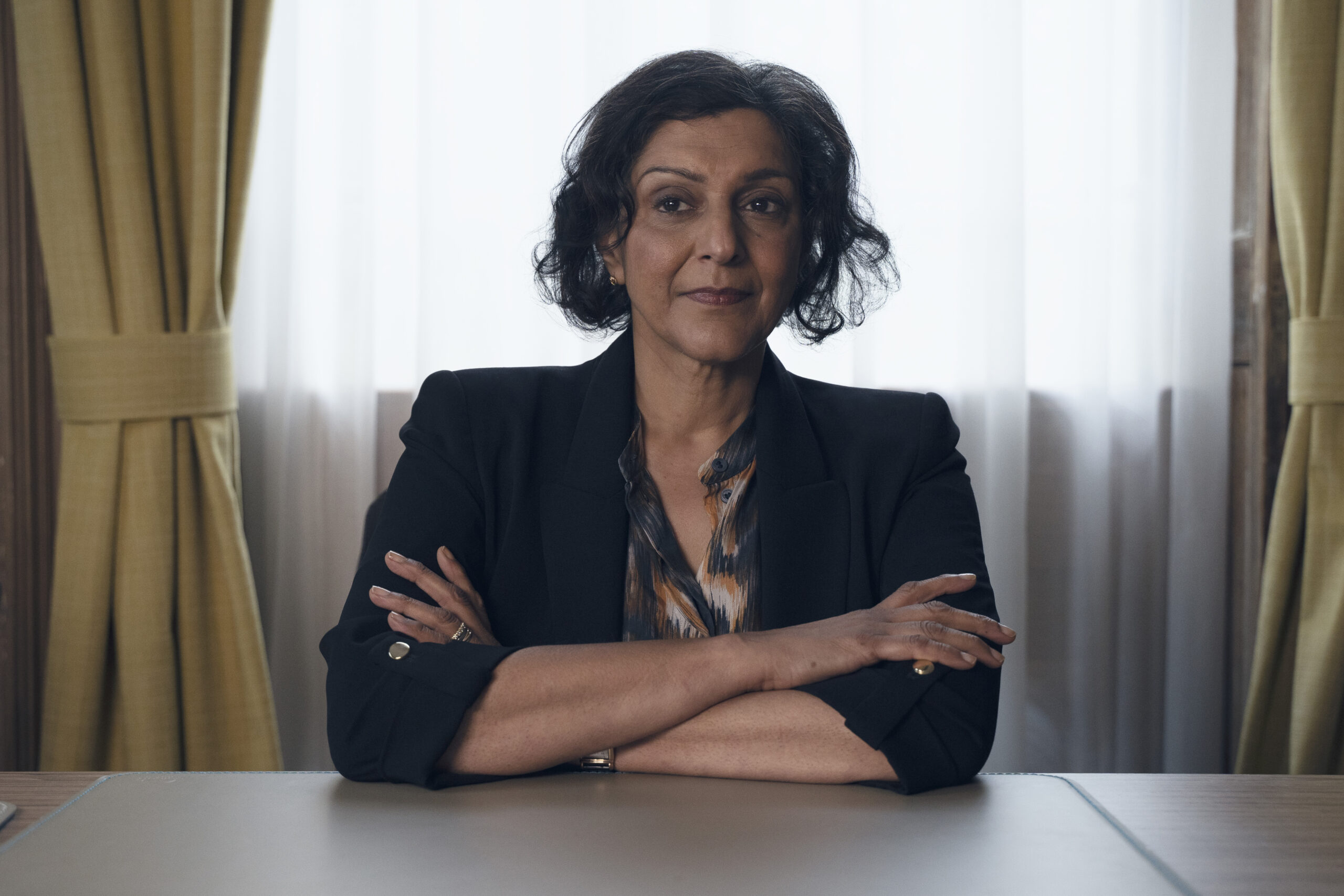 Meera Syal smiling enigmatically as Ruby Bennett in The Devil's Hour