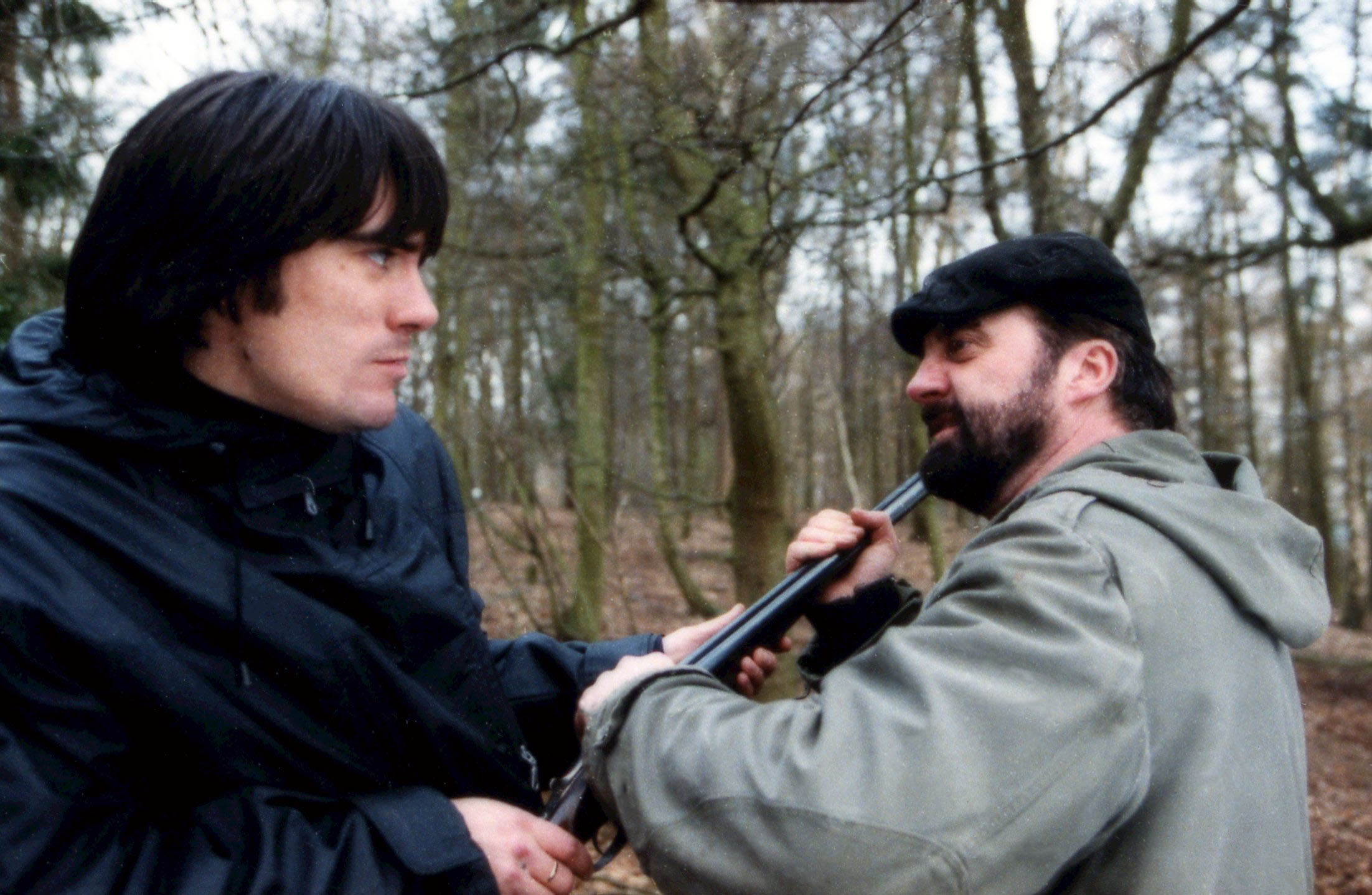 Emmerdale Cain holds a shot gun near Zak