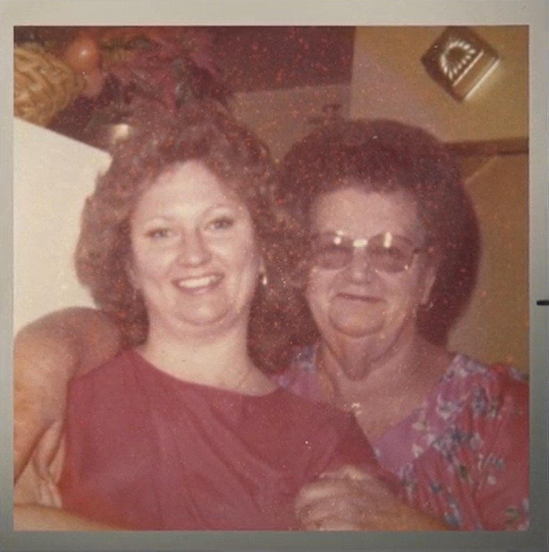 Sheryl Kellison poses with her mother, they stand close and smile together