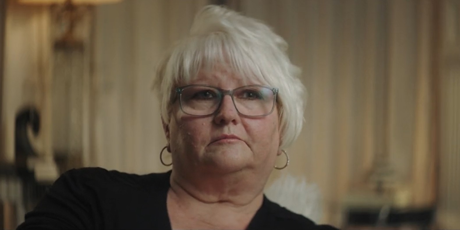 Sheryl Kellison in 2022, she frowns in a black shirt and glasses