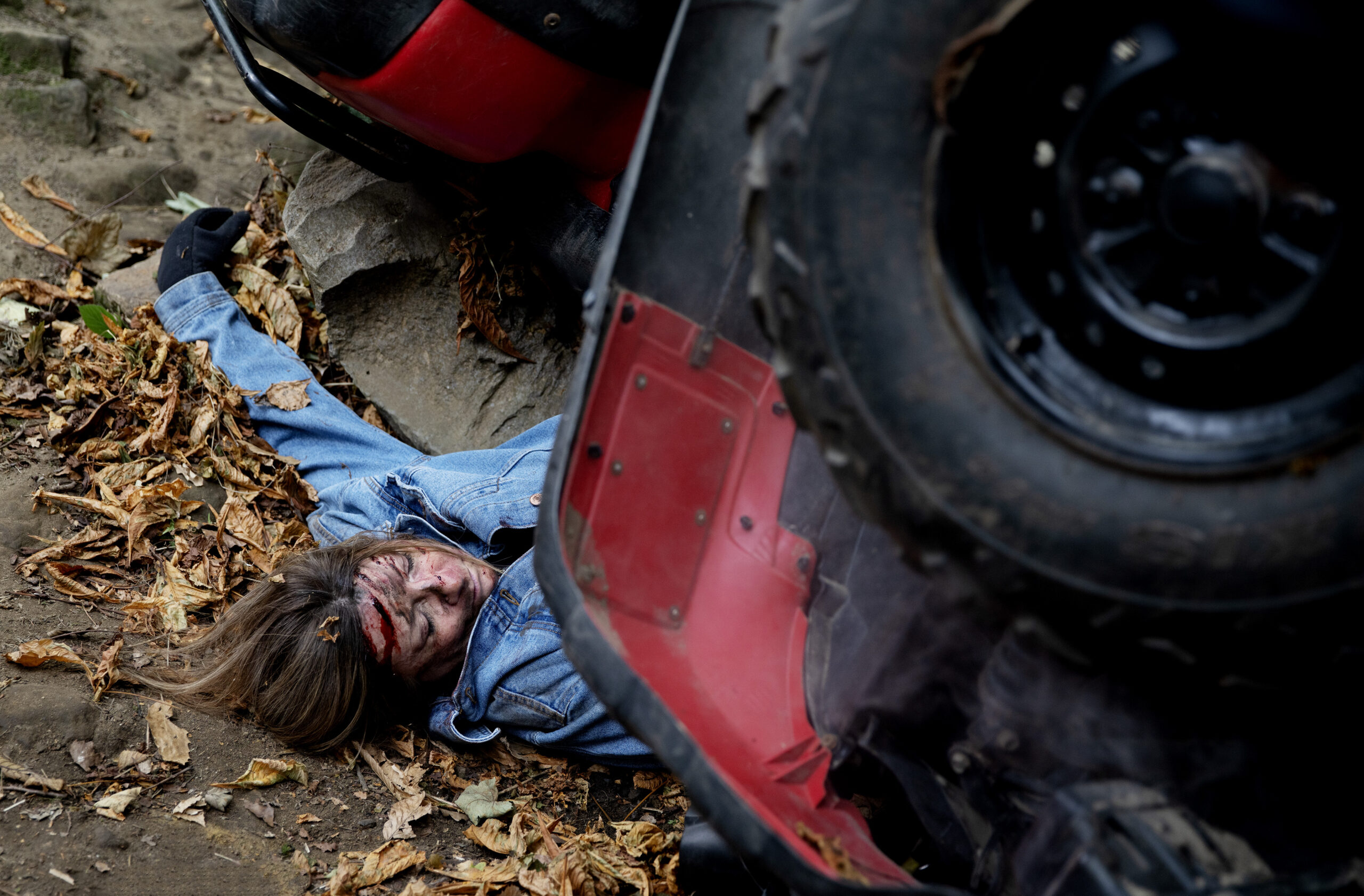 Harriet under a quad bike covered in blood in Emmerdale 