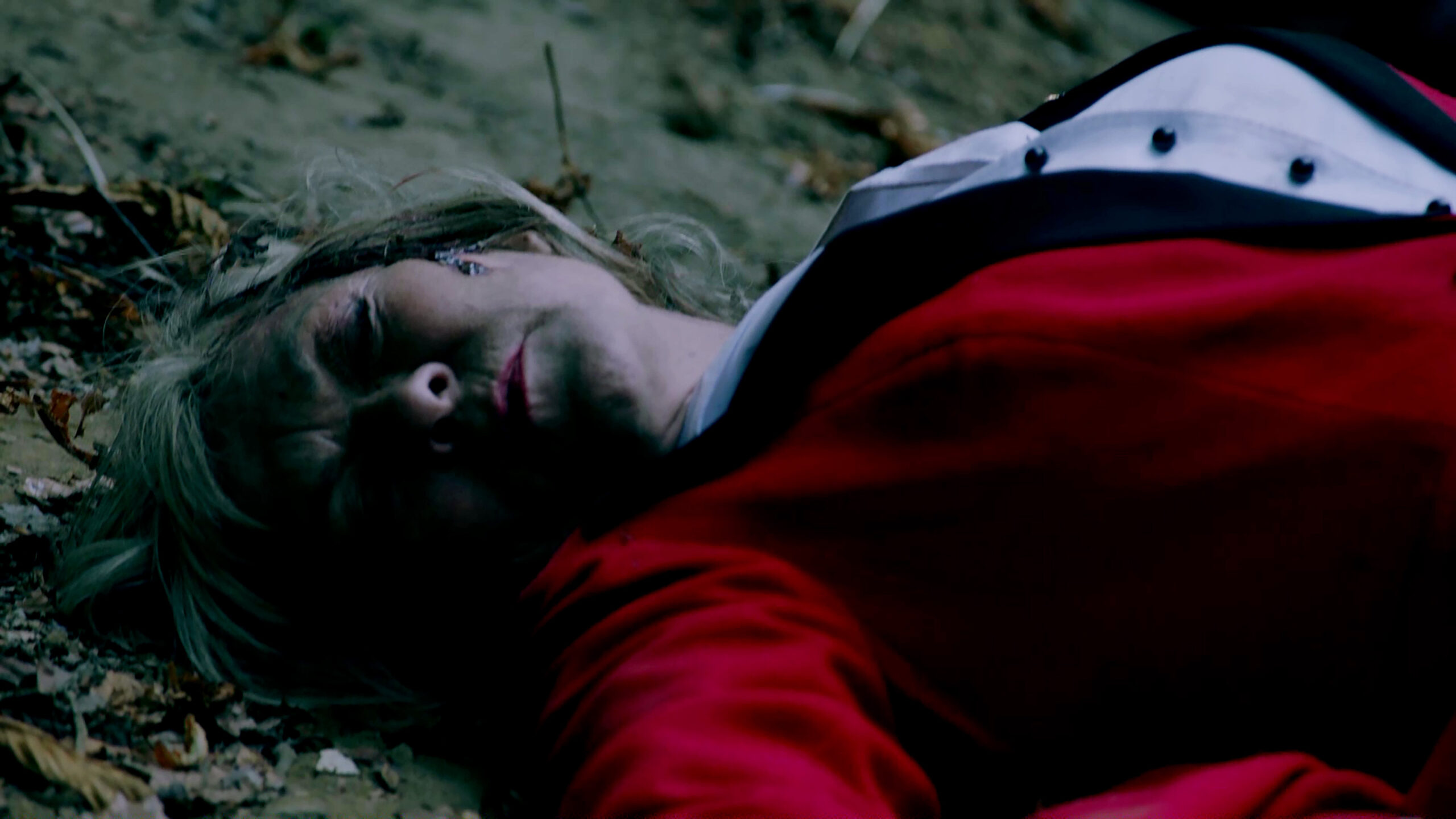 Kim Tate lying unconscious on the ground in Emmerdale