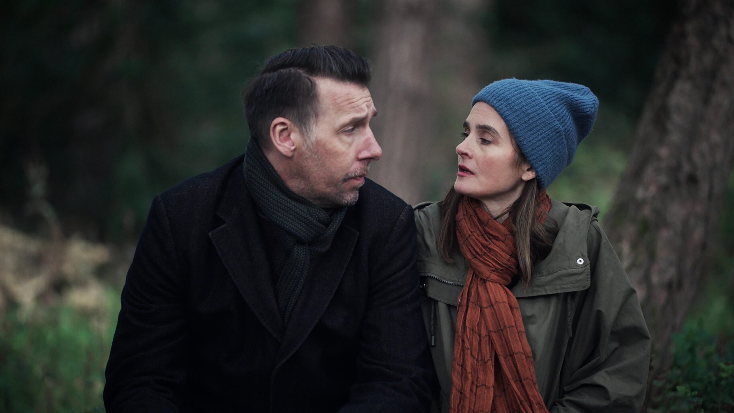 The House Across The Street CLAUDIA, (SHIRLEY HENDERSON) and GEORGE, (CRAIG PARKINSON), they look at each other as they sit on a bench in the woods