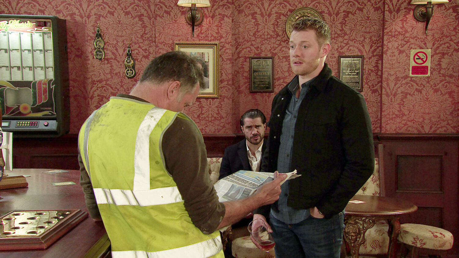Daniel looking worried and Adam looking annoyed at Arnie in Corrie