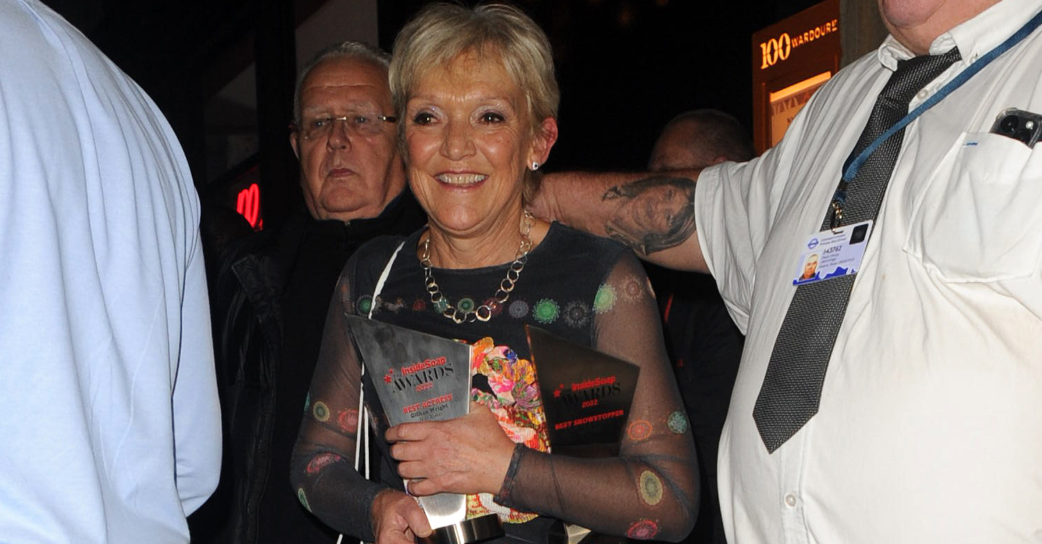 EastEnders Gillian Wright smiling whilst holding two Inside Soap Awards