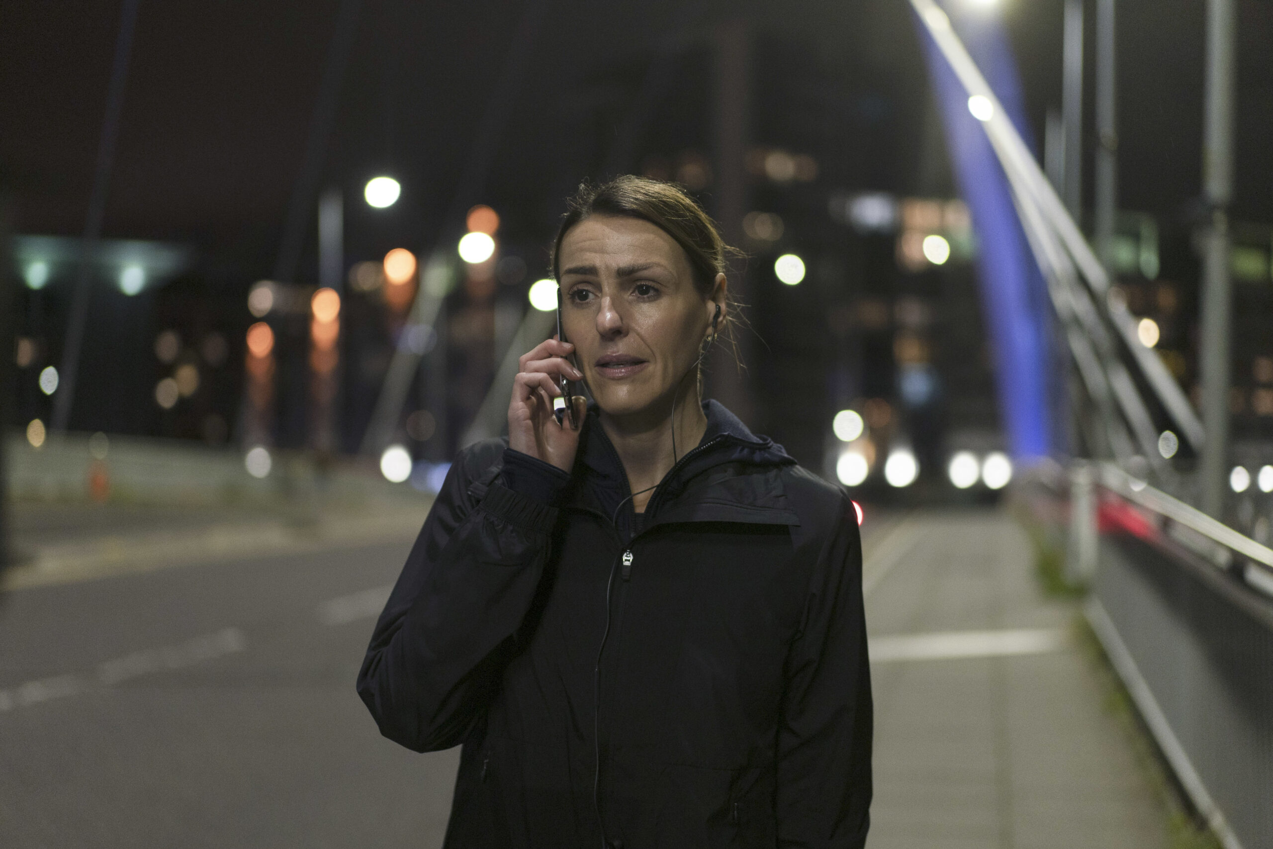Suranne Jones talks into a phone in character in Vigil